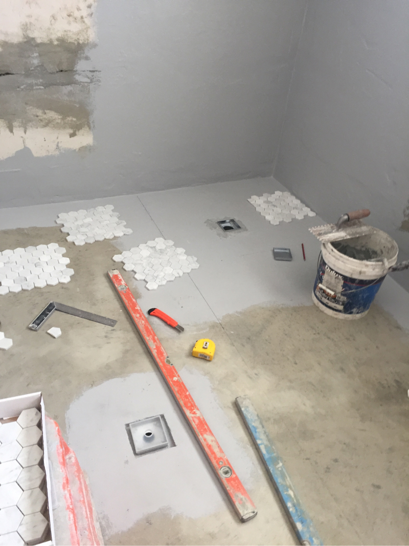 Professional tile preparation - screeding a bathroom floor in Yanchep by Tiling Creations.